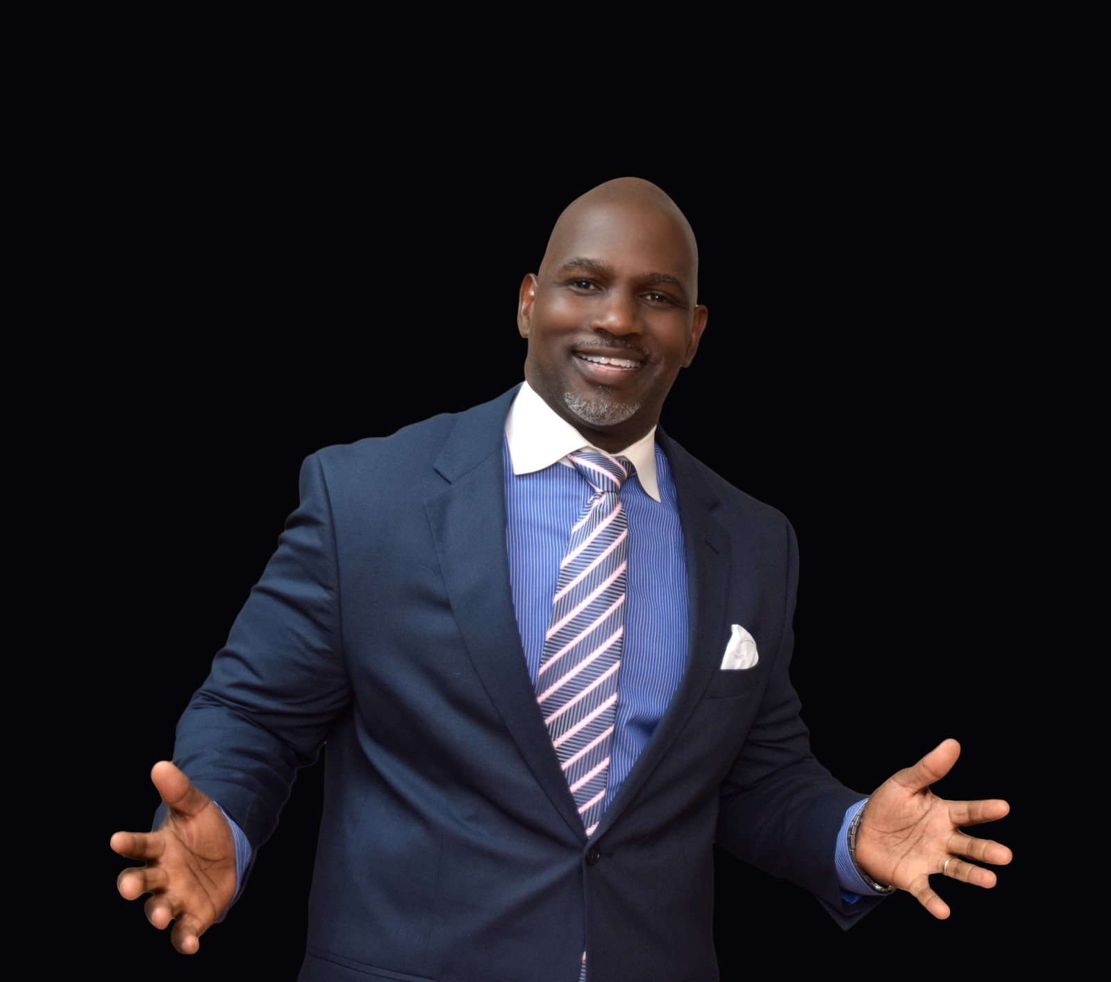 Adrian Cox in a navy suit, studio portrait